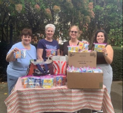 Chapter members -Linda DiCarlo, Lisa Gehrung, Michele Burke, and Erica Zippo prepare breakfast packs to donate to Meals-4-Kids